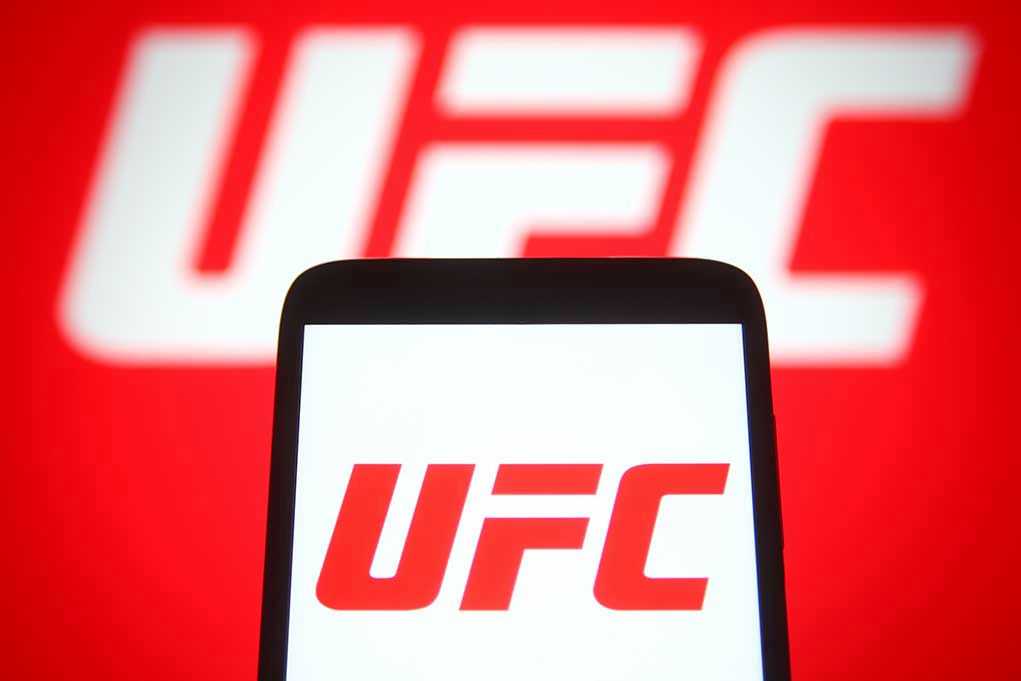 UFC logo on phone screen and background.