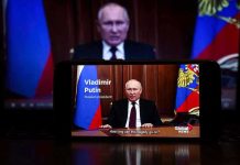 Tensions Explode: Russia’s Peace Rejection Man speaking on screen with Russian flag background.