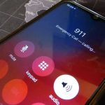 Criminals Target 911 Systems—Americans Die Phone screen showing 911 emergency call in progress.