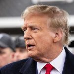 Trump Sparks CHAOS Over Epstein Vote Man in suit and red tie speaking outside.