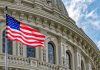 US flag in front of Capitol building.