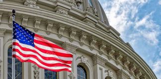 US flag in front of Capitol building.