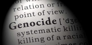 Close-up of the word Genocide in a dictionary with its definition