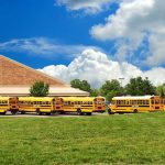 Horrifying Abuse Claims Shake Connecticut Schools A row of yellow school buses parked in front of a school building under a cloudy sky