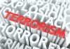 The word TERRORISM in bold red letters surrounded by related terms in white