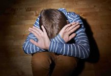 Outrage Erupts: Camp Leader’s Sickening Crimes Unchecked A child sitting on the floor with their hands covering their face, expressing distress