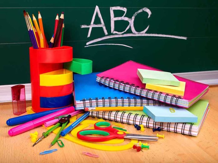 A collection of colorful school supplies including notebooks, pens, and scissors on a desk