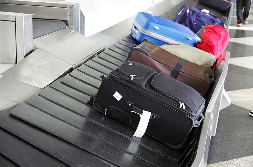 Various suitcases on an airport luggage carousel
