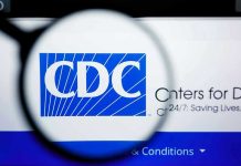 CDC Quietly Guts Long-Standing Newborn Shield CDC logo magnified on a screen.
