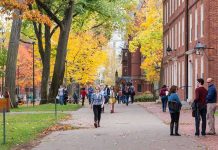 Conservative Tribute Sparks Major Legal Battle People walking on a college campus in autumn.