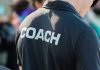 Person wearing a shirt labeled Coach.