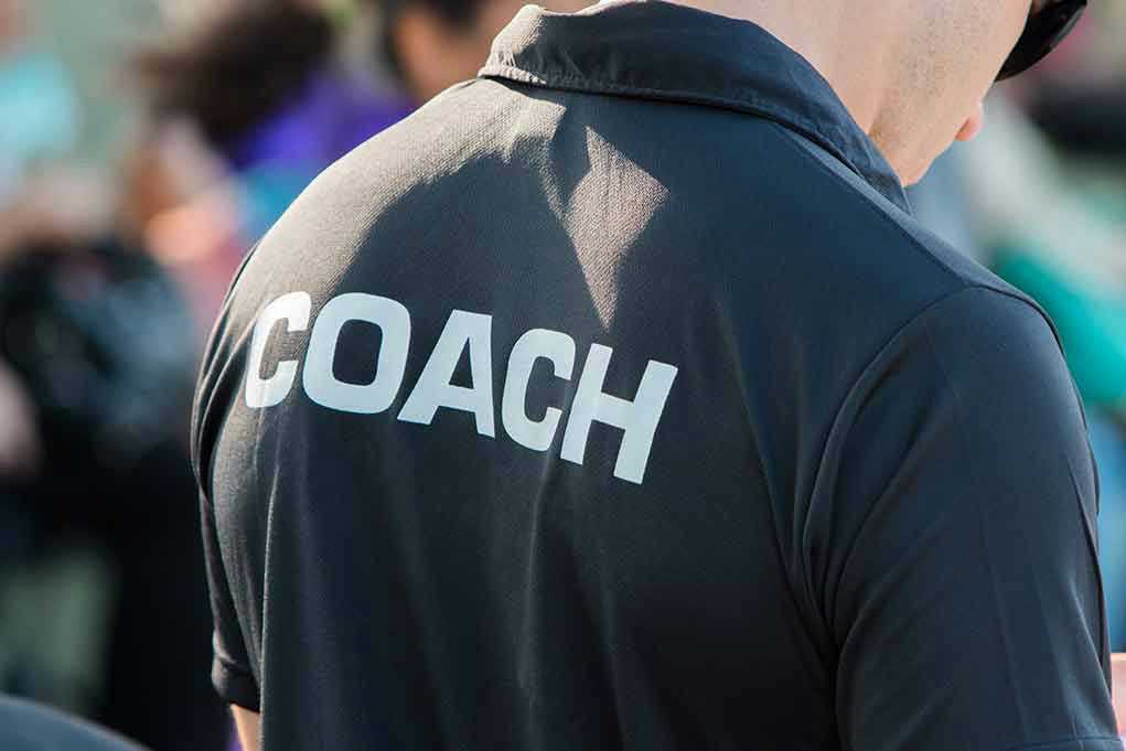 Person wearing a shirt labeled Coach.