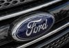 Ford CEO Panics Over Chinese EV Onslaught Ford logo on car grille close-up.