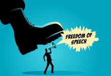 A man holding a megaphone under a large boot, symbolizing censorship of free speech