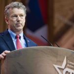 A man speaking at a podium during a political conference