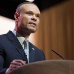 Bongino’s FBI Role Sparks Massive Outcry A man in a suit speaking at a podium during a conference