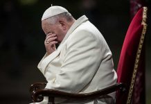 Vatican Document STUNS with Gay Blessing Approval Pope sitting with his head bowed and hand covering his face