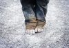 200,000 Child Deaths Loom—Who’s Responsible? A child standing barefoot on a gravel surface with dirty pants