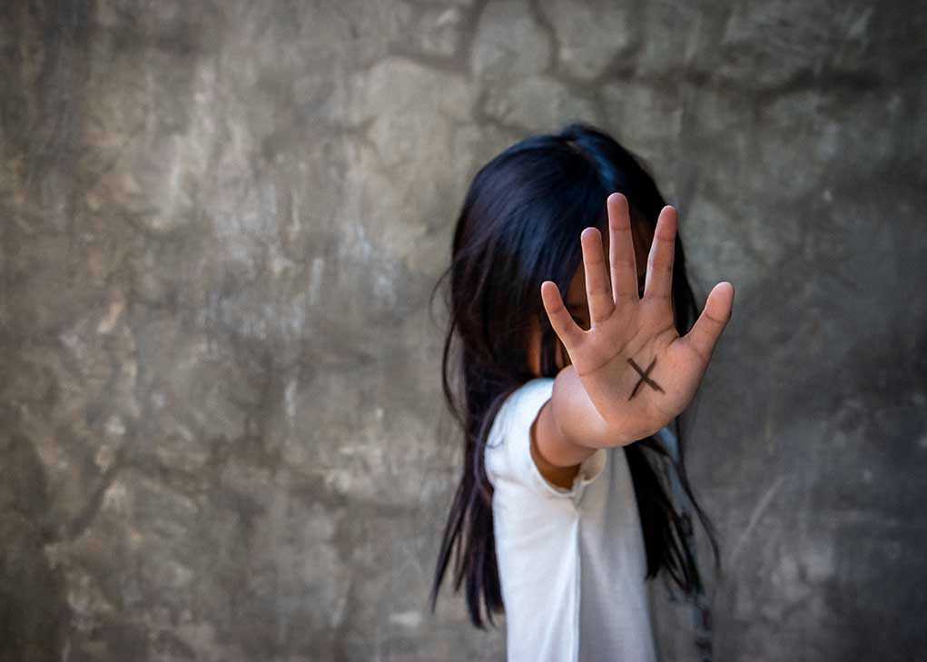 Person with an X on their palm.