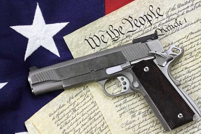 129482747 Gun on U.S. Constitution and flag.