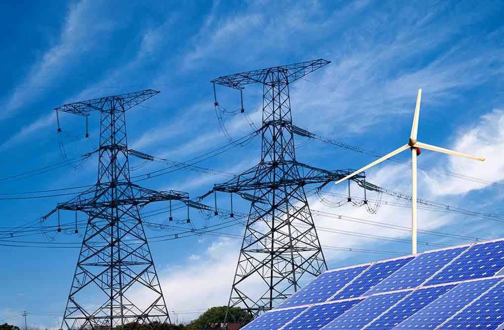 Power lines, solar panels, and wind turbine against sky.