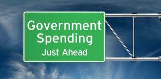 Green road sign: Government Spending Just Ahead.