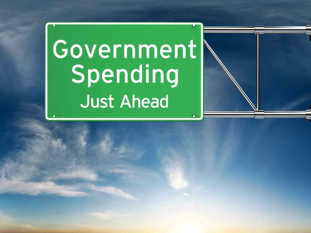 Green road sign: Government Spending Just Ahead.