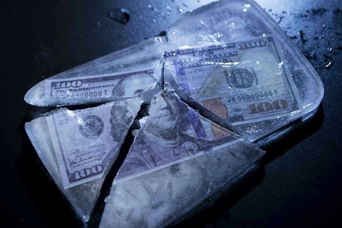 331569191 Hundred-dollar bills frozen in cracked ice block.