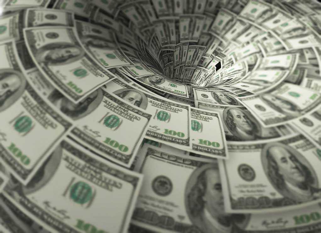Hundred-dollar bills swirling into a financial vortex.