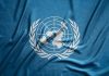United Nations flag featuring a world map and olive branches on a blue background