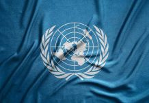 United Nations flag featuring a world map and olive branches on a blue background