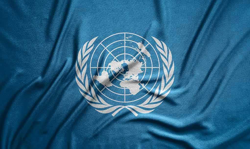 United Nations flag featuring a world map and olive branches on a blue background
