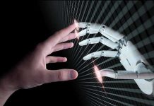 AI Tilts Toward Armageddon Human and robotic hand reaching out to touch.