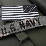Navy Chief Orders MASSIVE Workforce Bloodbath U.S. Navy patch with black-and-white American flag.