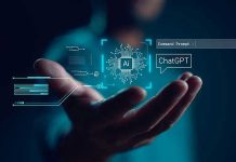 Hand holding digital AI and ChatGPT graphics.