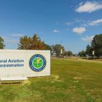 FAA Chief in HOT Seat Federal Aviation Administration sign on grassy lawn.