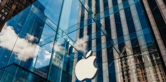 Apple CAVES to Kremlin — VPN Crackdown Explodes Apple store with glass facade and city reflections.