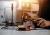 Gavel being struck near scales of justice.