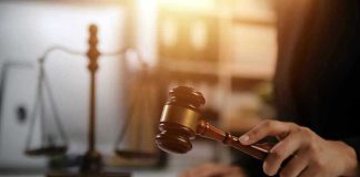 Gavel being struck near scales of justice.