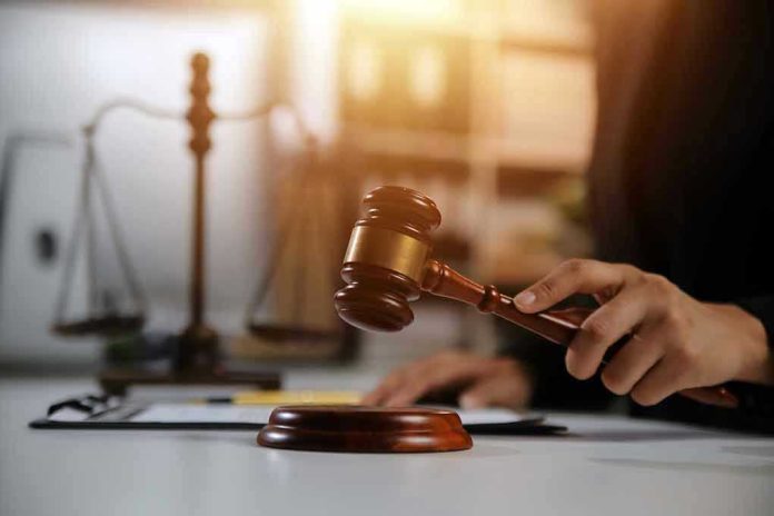 Gavel being struck near scales of justice.