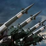 Why “WWIII” Talk Is Growing Four rockets pointed towards the sky.