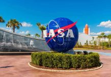 NASA logo sculpture with spaceship and palm trees.