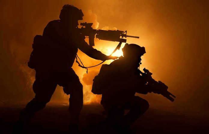 Two soldiers with weapons silhouetted against fiery background.