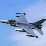 Fighter Jet Revolution: U.S. Air Dominance On The Line Jet fighter flying through clear blue sky.