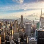 What It Really Takes to Live Comfortably in America New York City skyline with Empire State Building.