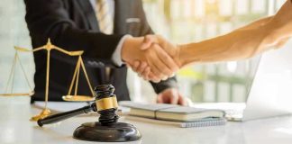 Federal Indictment Fuels Questions Over Politicized Leaks Hands shaking over legal documents with gavel and scales.