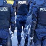 Bar’s “Free Beer Day” When Trump Dies BACKFIRES Police officers in riot gear with shields.
