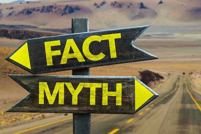 346512248 Directional signs labeled Fact and Myth in desert.