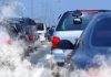 Traffic jam with cars emitting exhaust fumes on a city road