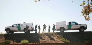 Border Crisis Twist: The Drugs Slip Elsewhere Border Patrol vehicles and agents on a ridge.